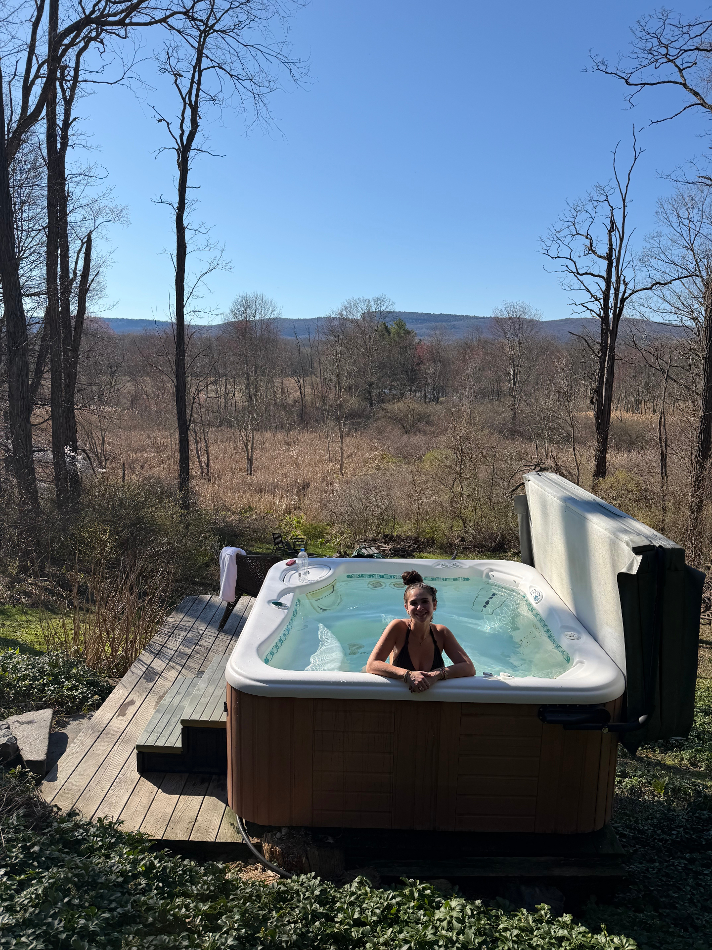 Founder of Heala in a hot tub overlooking the countryside